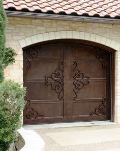 a large brown garage door in front of a house