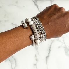 Add extra dazzle to your outfit with this gorgeous stack of bracelets. With a mix of delicate and bold pieces, sparkly rhinestones and glimmering metallics, the Annabella bracelet stack has everything you need to dress up any look. This bracelet stack includes: - Terri stainless steel and rhinestone cuff bangle - Tanisha howlite beaded bracelet with rhinestone bar - 2 Nakia stainless steel beaded bracelets (6mm and 8mm) - Nyoki stainless steel bracelet This bracelet stack will fit wrists up to 7 Chic Silver Stackable Bracelets, Trendy Silver Cubic Zirconia Tennis Bracelet, Stackable Cubic Zirconia Bracelets For Party, Glamorous Adjustable Bracelet With Bling, Trendy Stackable Metal Beaded Bracelets, Adjustable Bling Beaded Bangle Bracelets, Adjustable Glamorous Bling Bracelets, Trendy Metal Stackable Beaded Bracelets, Glamorous Adjustable Bling Bracelets