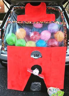 a trunk filled with lots of different colored balls in it's back compartment,