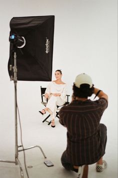 a woman is sitting in front of a camera