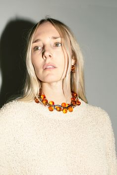 A chunky, linked statement necklace punctuated with amber colored beads. About 19" long including the clasps. Elegant Orange Glass Jewelry, Elegant Amber Jewelry With Large Beads, Orange Large Beaded Jewelry For Party, Elegant Baltic Amber Necklace In Orange, Elegant Orange Baltic Amber Necklace, Saturn Necklace, Amber Color, Amber, Statement Necklace