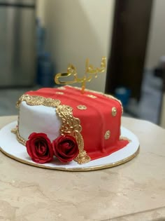 a red and white cake sitting on top of a table