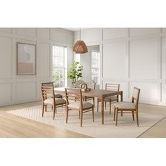 a dining room table and chairs with white walls