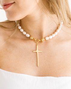 Susan's latest cross design is an elongated, handmade depiction symbolizing far reaching love. Cross Pendant Necklace With Pearl Charm, Pearl Drop Cross Pendant Necklace As Gift, Pearl Drop Necklace With Cross Pendant For Gift, Pearl Drop Necklace With Cross Pendant As Gift, Pearl Crucifix Necklace As Gift, Gold Cross Necklace With Pearl Charm, Gold Cross Necklace With Pearl Chain, Gold Cross Necklace With Pearl Pendant, Pearl Cross Necklace With Pearl Charm As Gift