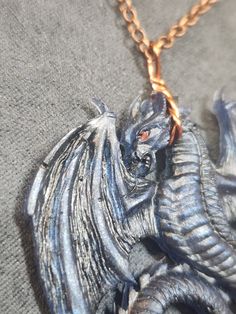 Resin Dragon pendant with hand-painted details Handmade Gothic Blue Necklace, Handmade Blue Gothic Necklace, Fantasy Necklaces For Halloween Gift, Blue Fantasy Jewelry For Gifts, Blue Fantasy Jewelry For Gift, Hand Painted Jewelry For Halloween Gift, Themed Hand Painted Jewelry For Gifts, Fire Pendant, Resin Dragon