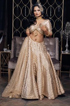 This intricate beauty is such a beautiful array of heritage with a glimpse of a modern day bride! This duo of a radiant Banarsi Silk lehenga and a trendy cut blouse is the perfect go to look for our fashionable divas! #vamadesigns #indianwedding #bollywood #indianbride #lehenga #gold #goldlehenga #punjabiwedding #indianwear#indianfashion #traditionalwear #indianwedding#punjabiwedding #desiwedding #indianbride#bridalwear #bride #sangeet#bridalfashion#bridaloutfit#weddingoutfit #bridal #golden Floor-length Brocade Choli With Dupatta, Party Wear Embroidered Raw Silk Lehenga, Embroidered Raw Silk Lehenga For Party, Navratri Brocade Lehenga With Dupatta, Party Embroidered Raw Silk Lehenga, Navratri Brocade Choli With Intricate Embroidery, Floor-length Organza Set With Intricate Embroidery, Festive Choli With Intricate Embroidery, Party Lehenga With Intricate Embroidery In Raw Silk