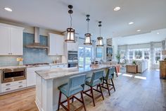 a large kitchen with an island in the middle and lots of counter space on one side