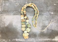 "These wonderful beads were excavated along the Silk Road in Afghanistan. \"The terms \"Roman\" and \"Roman period\" glass are used to describe glass production from 100 BC to AD 400 within the boundaries of the Roman Empire, including factories in Syria, Egypt, Italy, Switzerland, the Rhineland, France and England. Everywhere the Romans went, they brought glass beads to trade.\" From \"History of Beads\" by Lois Sherr Dubin, pages 55-58. To wear as it is or to use for your own projects! ✔️Roman Ancient Handmade Healing Necklace, Ancient Style Pendant Necklaces, Handmade Ancient Style Necklaces With Round Beads, Vintage Necklace With Round Gemstone Beads, Jewelry Ancient, The Silk Road, Ancient Roman Glass, The Roman Empire, Archaeological Finds