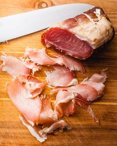 a knife and some meat on a cutting board