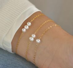 Our gift to you 10% off your first purchase. Details here - http:/eepurl.com/dpVPBzYou have found the perfect dainty pearl bracelet. Available with 1, 2 or 3 pearls. Personalize the number of pearls with your wishes, goals, children etc. Perfect for that special occasion yet simple enough for every day wear. You and your loved one will adore this meaningful gift.....................DETAILS14 k fill or Sterling Silver.Choose 1, 2 or 3 pearls.Each fresh water pearl is unique meaning the size and s Pearl Chain Bracelet As Gift, Minimalist Pearl Bangle Bracelet Gift, Pearl White Pearl Bracelets For Gift, Pearl White Pearl Bracelet As Gift, Pearl White Pearl Bracelet Gift, Pearl Bracelet Jewelry As Gift, Pearl Drop Bracelet As Gift, Pearl Drop Bracelet Jewelry Gift, Round Pearl Bracelets As Gift