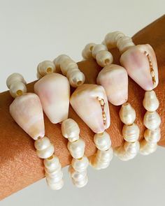 Super sea tumbled Hawaiian cone shell paired with genuine white fresh water pearl beads! The tumbling has worn off the original colors to reveal a soft pastel hue! Takes many many years in the surf to create this color way.  You will receive a randomly picked pastel shell that may vary in hue from: white/peach/tan/lavender/pinkish/brownish NOT guaranteed to have sand in it. Stretch cord style. Hidden knot. 7 inches beaded. Can fit sizes 6-8 inch wrist. If you need a specific size please leave a note at check out! Perfect for stacking! USA shipping included. International shipping fees apply and you can look up your price by country before you check out in the shipping section. Free shell gift with every order! Hidden Knot, Gold Inspiration, Cone Shell, Jewelry Photoshoot, Beadable Products, Wire Work Jewelry, Shell Bracelet, Fresh Water Pearl, Shell Jewelry