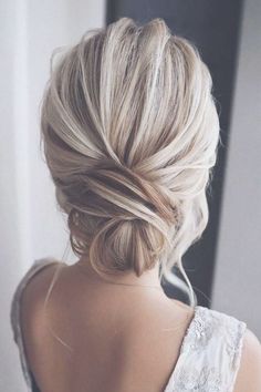 the back of a woman's head, with her hair in a low bun