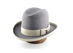 "Fedora | The EARL | Styled and finished by hand Customize it to match your physical characteristics and lifestyle. Personalize it to reflect your unique statement. At a glance: - Available in any color combination from our swatches - Tried and true handmade quality - Designed to fit your exact head measurement comfortably - Delivered safely inside a round hat box - Includes a protective organic cotton drawstring bag - Comes with care instructions - Three delivery options Specifications: - Class Adjustable High Crown Silver Hat, Adjustable Silver High Crown Hat, Western Silver Hat With Short Brim, Silver Hat With Curved Brim For Formal Occasions, Formal Short Brim Silver Hat, Western Style Silver Hat With Flat Brim, Trilby Hat Men, Wide Brim Hat Men, Women Fedora