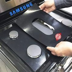 a person is opening the door to an oven that has two burners on it