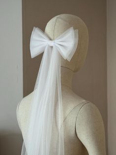 the back of a mannequin with a white bow on it