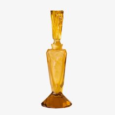 an orange glass vase with a figure on it's side, against a white background