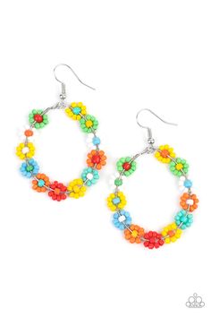 the multicolored flower hoop earrings are hanging from silver hooks on a white background