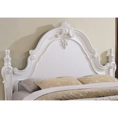 a white headboard and foot board in a bedroom