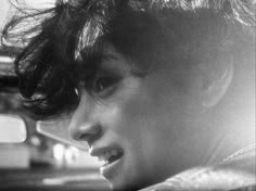 black and white photograph of a woman's face with hair blowing in the wind