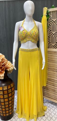 Amp up your party wardrobe with Anandi Fashions' stylish and latest fashion- Yellow Georgette Crop top party wear sharara. Crafted for the modern woman who values tradition, this eye-catching ensemble combines the elegance of ethnic wear with a contemporary twist. Perfect for any festive occasion, the vibrant yellow georgette fabric complements the chic crop top and flowing sharara, ensuring you stand out effortlessly. Explore our wide range of Indian ethnic wear, including sarees, blouses, and Evening Party Wear Georgette Palazzo Set, Party Wear Saree Set For Evenings, Embellished Sharara For Festive Party Season, Elegant Floor-length Pant Set For Festive Occasions, Elegant Floor-length Festive Pant Set, Festive Embellished Sharara For Party Season, Elegant Festive Floor-length Pant Set, Evening Palazzo Set With Resham Embroidery For Diwali, Designer Party Wear Palazzo Set For Festive Season