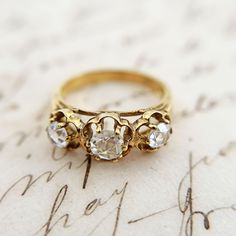 An antique 10K gold ring with 2 rosecut or "gulugud-pagong" diamonds and 1 glass stone from the Philippines.   When you see this ring up close, the 3 stones look very similar.  They have really good clarity and the 2 diamonds have very minimal inclusions.  As for the 3rd stone, we had to check several times as it looked like a diamond but tested as glass!  So when you wear this, you won't be able to tell visually which one is not a diamond. A 3-stone ring is a popular design said to represent th 10k Gold Ring, 3 Stone Rings, Rose Cut Diamond, The Philippines, Stone Ring, 10k Gold, Rings Statement, Stone Rings, Gold Ring