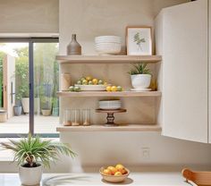 the shelves in the kitchen are filled with fruit