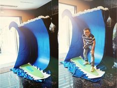 a man standing on top of a surfboard in front of a wave shaped display