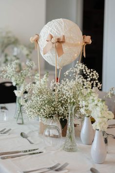 a table topped with vases filled with baby's breath