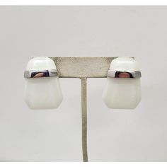 1980s Modernist geometric rhodium plated white Lucite pierced push back earrings. Marked "TRIFARI©" and "Kunio Matsumoto" both in script. Measure: 1 3/8 inches long by 1 inch wide.   Excellent condition. Identical earrings were featured in an advertisement, year unknown. Modern White Earrings For Formal Occasions, Modern White Clip-on Jewelry, Modern White Clip-on Earrings, Retro White Earrings For Formal Occasions, White Retro Earrings For Formal Occasions, White Retro Formal Earrings, Abstract Earrings, Van Cleef And Arpels, Opal Earrings Stud