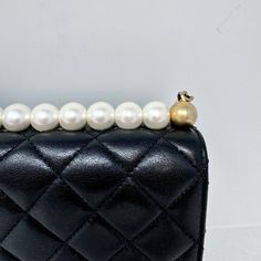 Chanel 2019 Quilted Small Chic Pearl Flap Bag with Interlocking CC Turn-lock and Gold-tone Hardware (with Dustbag) Designer = Chanel Color = Black Material = Leather Condition = Very Good Height = 6 Width = 8.5 Depth = 1.5 Class = Premier Location: Chicago Item Number: 19740-126 Item ID: 298142 Category: Shoulder Bag Pearl Chanel Bag, Classic Evening Bag With Lock, Elegant Top Handle Shoulder Bag With Lock, Formal Crossbody Bag With Pearl Handle, Luxury Crossbody Shoulder Bag With Pearl Handle, Luxury Shoulder Bag With Pearl Handle, Luxury Clutch Shoulder Bag With Pearl Handle, Luxury Pearl Handle Shoulder Bag, Elegant Evening Shoulder Bag With Lock