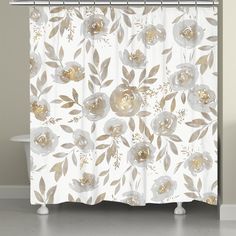 a white shower curtain with gold flowers on it