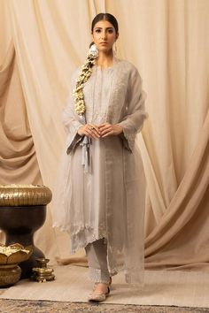 Silver pure organza silk straight-cut kurta with zardosi, resham and pearls embroidery. Comes with bamberg satin salwar and a dupatta.
Components: 3
Pattern: Embroidered
Type Of Work: Resham, Zardosi, Pearls
Neckline: Notched
Sleeve Type: Three quarter
Fabric: Kurta and Dupatta: Pure organza silk, Salwar: Bamberg satin
Color: Silver
Other Details: 
Elasticated waistband on pant
Attached lining
Length:
Kurta: 45 inches
Pant: 36 inches
Product Weight: 1 Kg
Model Height: 5ft 5inches, wearing size S Semi-stitched Sheer Dresses For Eid, Party Kurta In Organza With Cutdana Detailing, Silk Kurta With Sheer Dupatta For Transitional Season, Party Kurta With Cutdana On Organza, Transitional Silk Kurta With Sheer Dupatta, Party Organza Kurta With Cutdana, Elegant Organza Unstitched Suit For Reception, Elegant Silk Sets For Transitional Season, Elegant Fitted Silk Chiffon Sets