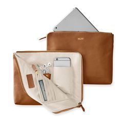 The best gifts are always the ones that make your life infinitely easier - like this beautiful leather clutch that doubles as a super-functional tech organizer. The zip-around closure opens to reveal multiple interior open and zipped pockets, leather tabs, card slots and plenty of space for your phone, keys, cards, cash, chargers, and other daily essentials. Add a foil debossed monogram for a personal touch.    11"w x 1"d x 9"h  Leather or suede exterior with a grosgrain lining.  See Product Inf Leather Gifts For Home, Travel Makeup Bag Leather, Leather Handbags Women Travel, Bag For Mac, Leather Sewing Accessories, Modern Desk Accessories Leather, Leather Art Supplies Bag, Gifts To Sew For Travelers, Gifts For Woman Who Travel