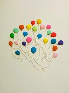 a bunch of balloons that are in the shape of a tree on a white background