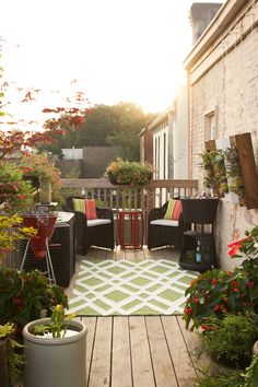 an outdoor patio with potted plants and chairs