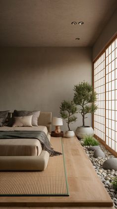 a large bed sitting in the middle of a bedroom next to a tree and rocks