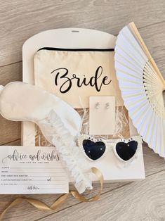 the bride gift set includes heart shaped sunglasses, an umbrella, and a card holder