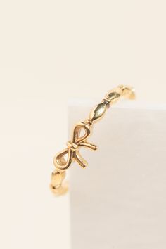 Elevate your style with our dainty Solid Gold Bow Ring - a symbol of timeless sophistication and feminine grace. Crafted with precision and care, this charming ring seamlessly combines the timeless allure of solid gold with a gracefully minimalist bow design. The dainty detailing makes it perfect for those who appreciate simplicity and subtle sophistication. Elevate your everyday look with a touch of refined elegance. This Dainty Solid Gold Bow Ring is perfect for birthdays, anniversaries, or any celebration. Its minimalist charm makes it a versatile piece that suits various personal styles. [ DETAIL ] * Gold kt option: 9k / 14k / 18k * Finish option: White gold / Yellow gold / Rose gold [ PROCESSING ] * Orders are shipped within 4 weeks but may be extended during some periods of the year Dainty Adjustable Rings For Promise Occasion, Dainty Adjustable Ring For Promise, Adjustable Yellow Gold Midi Rings For Formal Occasions, Dainty Open Band Stackable Rings For Formal Occasions, Adjustable 14k Gold Midi Rings For Formal Occasions, Dainty Stackable Rings For Formal Occasions, Adjustable 14k Gold Elegant Band, Elegant Sterling Silver Midi Rings For Promise, Elegant Adjustable Yellow Gold Stackable Rings