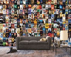 a couch sitting in front of a wall full of movie posters