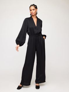 Introducing the Skyler Jumpsuit, made from shimmer material for a touch of glamour. With its relaxed fit and elastic waist, this jumpsuit is versatile and comfortable for a night out or formal occasion. Pair it with your favorite heels to complete the look. Size down to achieve a fitted look Shimmer Woven: 82% Viscose 18% Nylon Made in the USA of imported fabric Hand Wash Cold. Hang To Dry Or Dry Clean. Top length: 16 inches (size S) Long blouson sleeves V-neck Invisible back zipper closure Side Chic Evening Jumpsuits And Rompers For Fall, Chic Formal Jumpsuits And Rompers For Fall, Sleek Jumpsuits And Rompers For Spring Night Out, Sleek Evening Pantsuit For Spring, Chic Wide-leg Jumpsuits And Rompers For Loungewear, Elegant Fall Jumpsuits And Rompers For Date Night, Elegant Jumpsuits And Rompers For Fall Date Night, Elegant Fall Jumpsuit For Date Night, Elegant Jumpsuit For Date Night In Fall