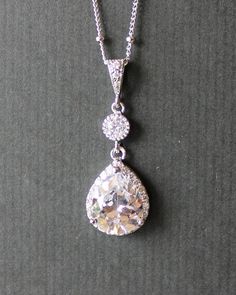 an image of a necklace with a diamond on it's back droplet hanging from a chain