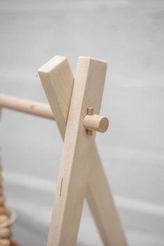 a close up of a wooden object on a chair with wood dows in the background