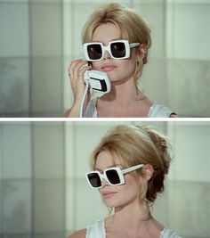 a woman in sunglasses talking on a cell phone and holding up her glasses to the side