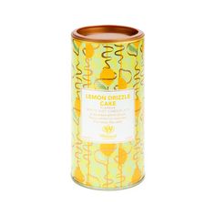 a yellow canister filled with lemon breezee cake on top of a white table