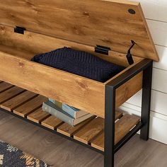 a wooden bench with books on it next to a wall