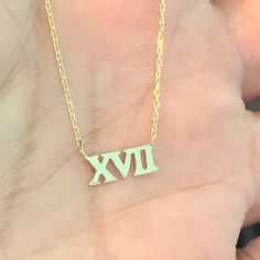 "This little classic Roman Numerals cut-out is composed of 14K solid gold and beautifully complemented by a durable 14K solid gold adjustable chain. This design is also available to be purchased as a charm alone without the chain. ♦ Dimensions: approximately 4mm (h) x 5mm to 9mm (w), depending on the number desired ♦ Metal Finish: High Shine Polish ♦ This design is available in Rose, White and Yellow 14K Gold ♦ Please note that this item takes about 3 to 5 business days for production, prior to Custom 14k White Gold Necklace For Anniversary, Custom 14k Gold Necklace, Classic Gold Custom Necklace For Anniversary, Classic Gold Custom Necklace With Hallmark, Custom Yellow Gold Necklace With Diamond Cut For Anniversary, Formal Gold Necklace Stamped 14k, Classic Gold Custom Necklace Hallmarked, Custom Yellow Gold Diamond-cut Anniversary Necklace, Dainty Custom Engraved 14k Gold Necklace