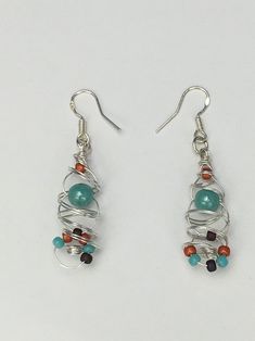 These earrings were fun to make.  I started off with non tarnish silver wire and started to coil a variety of colored beads into it to create a pair of earrings that can be worn with any outfit! 2" in Length. **All my jewelry comes packaged  in a nice Gift Box. Unique Multicolor Wire Wrapped Beaded Earrings, Unique Wire Wrapped Beaded Earrings With Round Beads, Silver Earrings With Colorful Beads, Adjustable Silver Earrings With Colorful Beads, Multicolor Wire Wrapped Earrings With Round Beads, Multicolor Wire-wrapped Beaded Earrings For Gift, Multicolor Wire Wrapped Beaded Earrings For Gift, Multicolor Wire Wrapped Beaded Earrings As Gift, Dangle Wrap Earrings With Silver Plated Wire