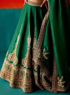 Dazzle in this dark green lehenga set, adorned with intricate embroidery highlighted by various embellishments. Paired elegantly with an embroidered dupatta, this ensemble is designed to make you stand out with its exquisite detailing and rich color, perfect for making a statement at special events. Dark Green Lehenga, Heavy Lehenga, Green Lehenga, Embroidered Lehenga, Embroidered Dupatta, Dupion Silk, Designer Dresses Indian, Silk Embroidery, Indian Designer Wear