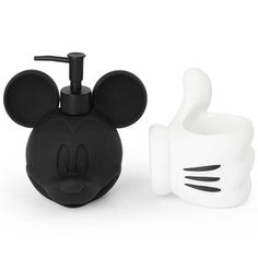 a mickey mouse soap dispenser and toothbrush holder are shown in this image