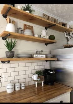 the shelves above the kitchen sink are filled with dishes and coffee mugs on them